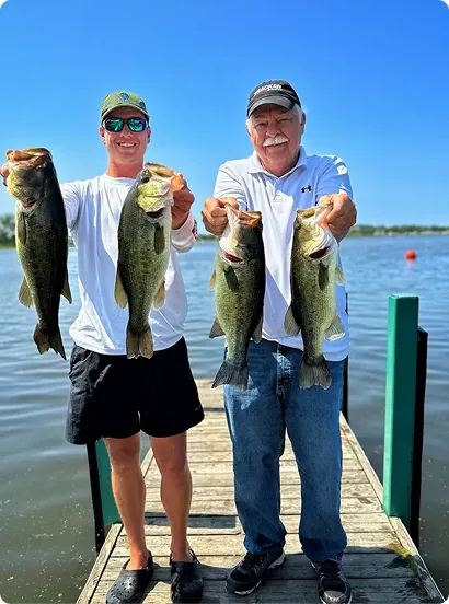 Captain Max and elderly guest holding their catch