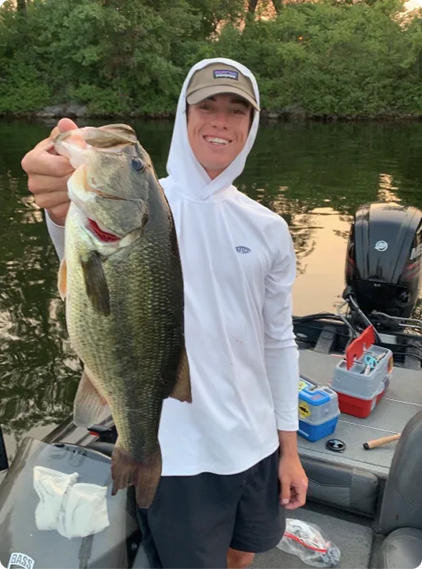 Captain Max on a fishing tour holding one bass