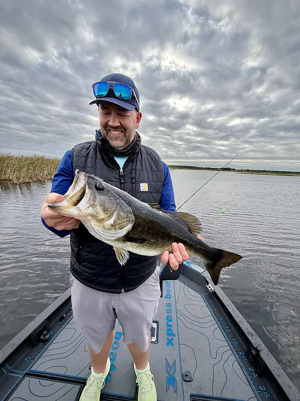 Man smiling with a big bass in his hands